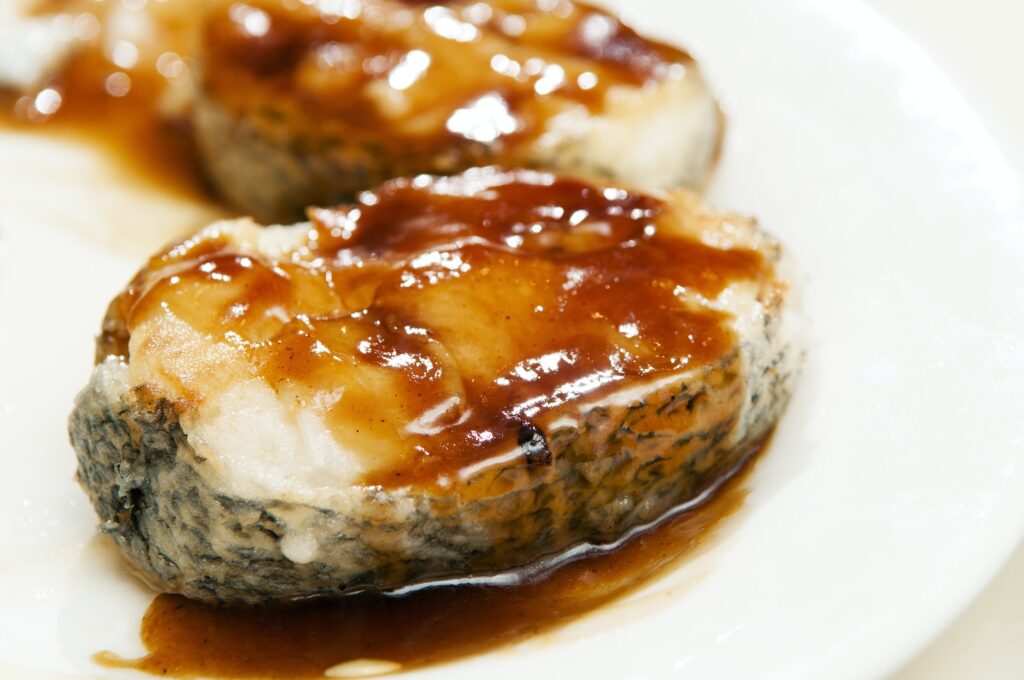 Close-up of baked cod fish with honey sauce